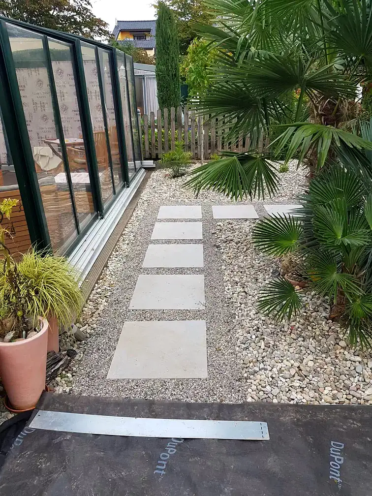 Neu angelegter Plattenweg mit Kiesbett und Bepflanzung